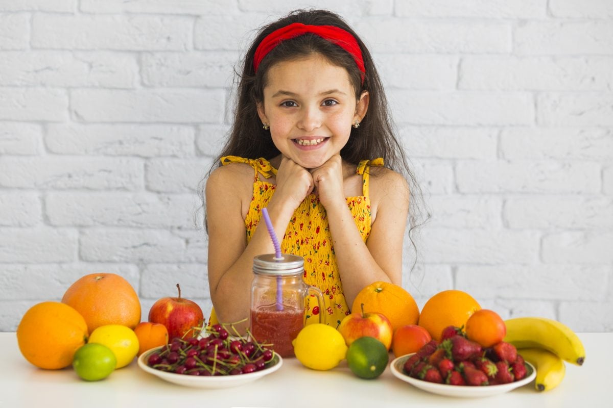 portrait girl standing table with fresh organic fruits 16772540673x2 R5hNs3