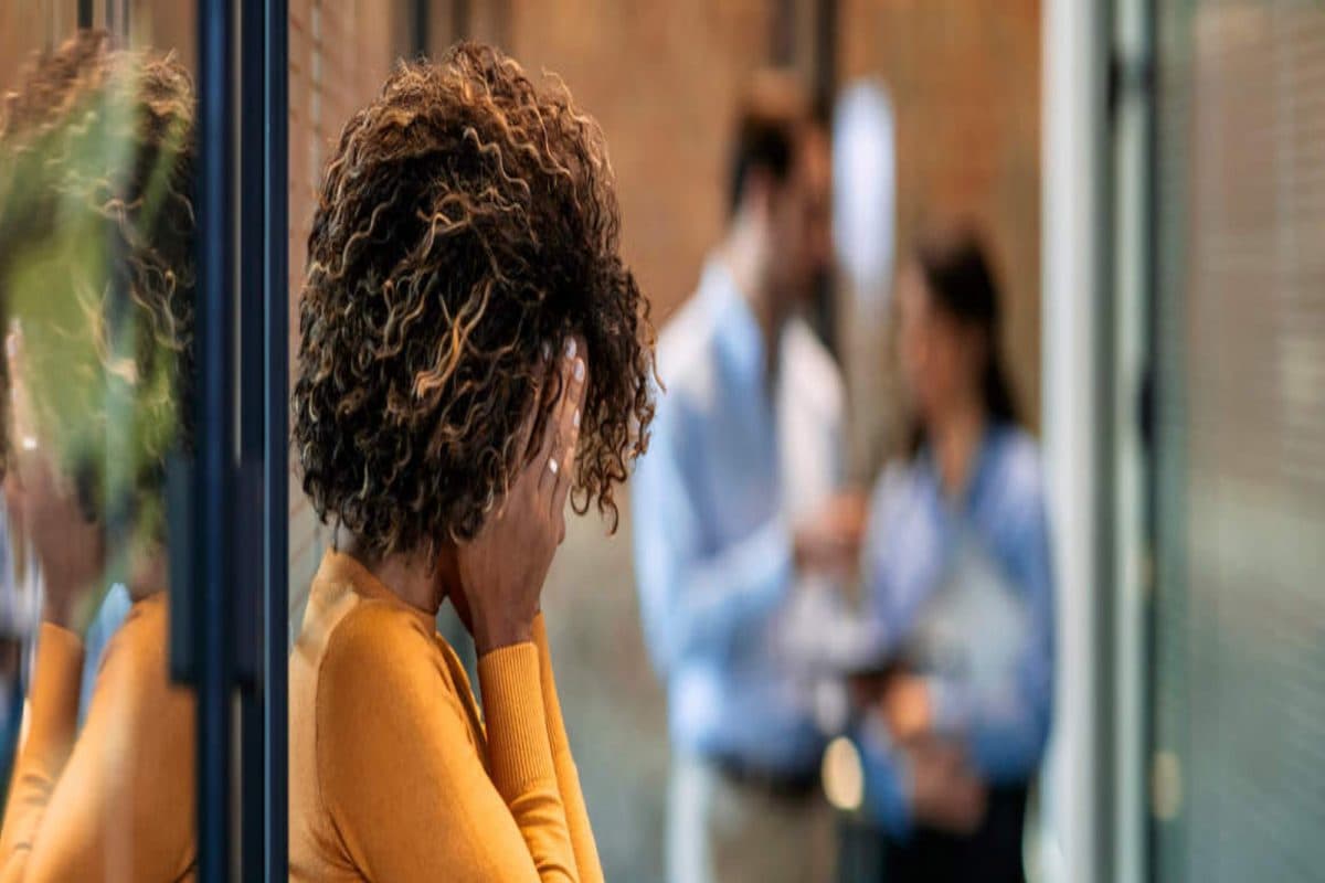 survivors guilt woman with head in hands at work 16754795143x2 ZUaH5r