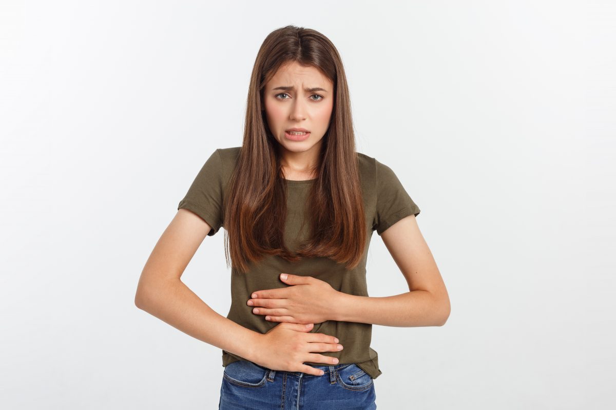 young beautiful asian woman having painful stomachache white background 16754219363x2 auqeB5
