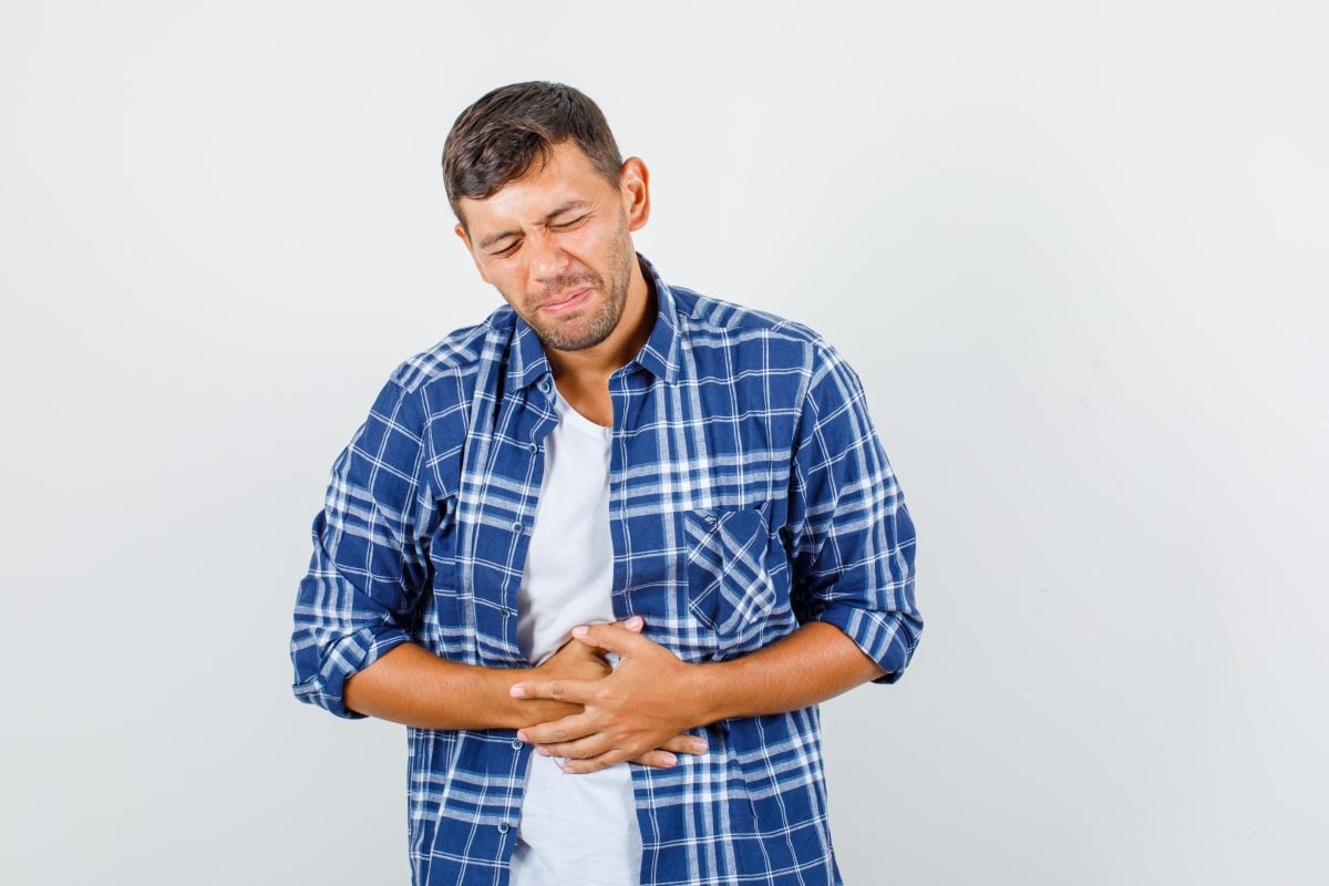 young man suffering from stomach ache shirt looking painful front view 16754126613x2 IzdsLc