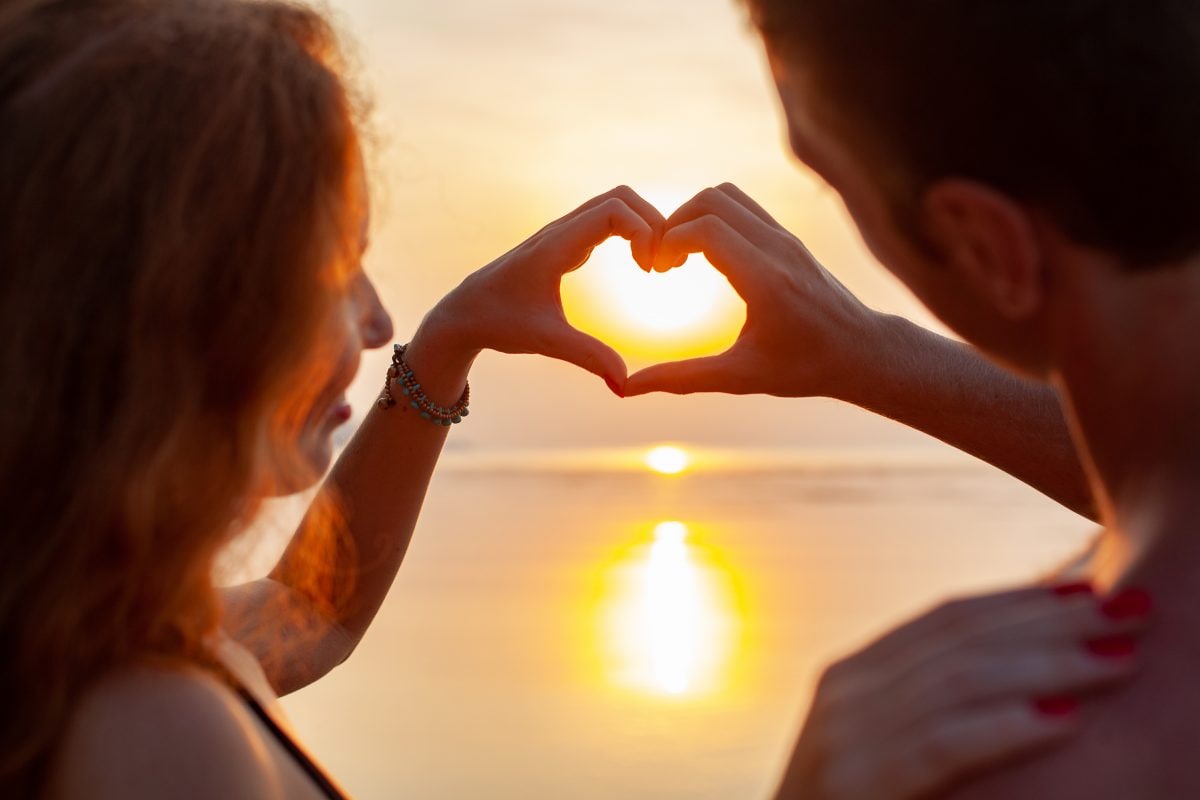 young sexy romantic couple love happy summer beach together having fun wearing swim suits showing heart sign sundet 16765612603x2 LwKSeK