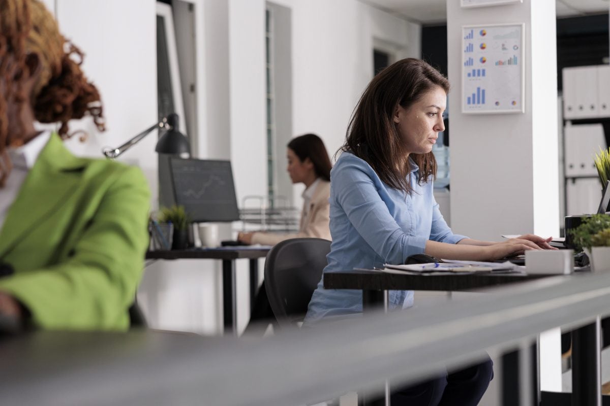 busy company employee working desk coworking space corporate manager workplace side view attractive serious woman typing laptop modern office selective focus 16749140493x2 nAidrt