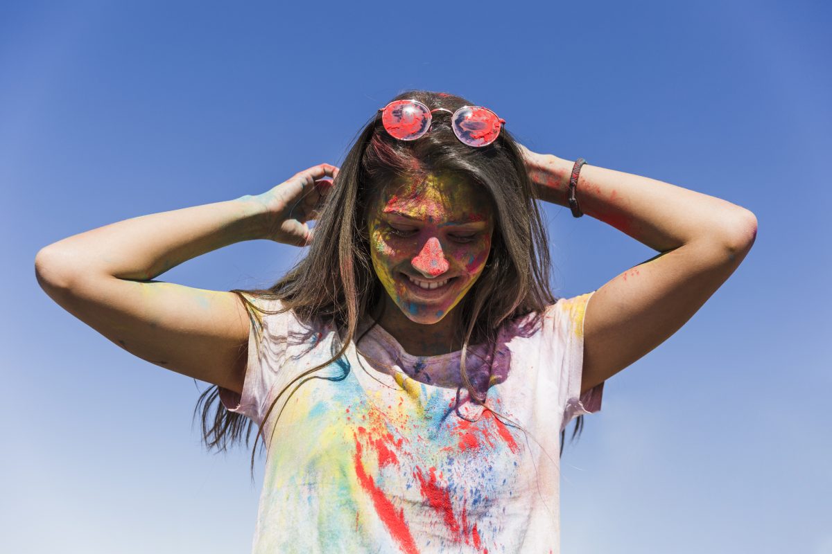 woman s face with holi colors standing against blue sky 16776914613x2 K15KwN